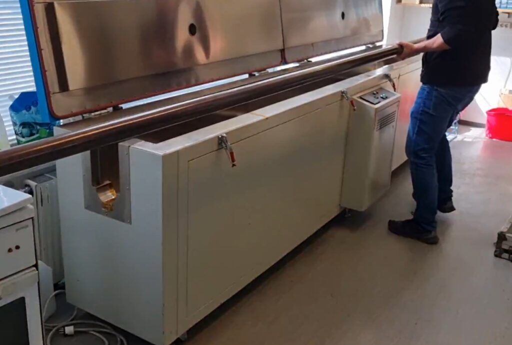 Technician preparing the PNNplus UHT tool for a high-temperature endurance test inside a laboratory oven at 200°C (400°F).